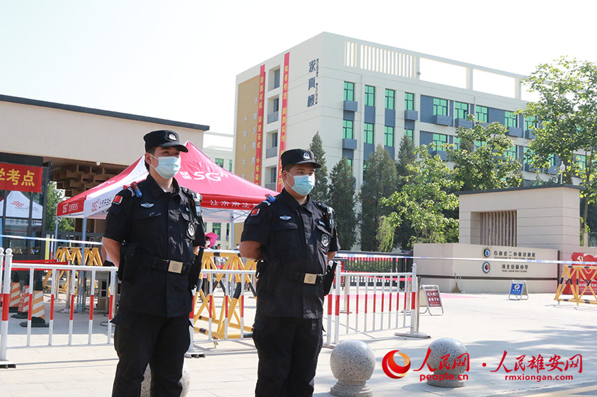 正在安新中學考點前執勤的民警。人民網 劉師豪攝