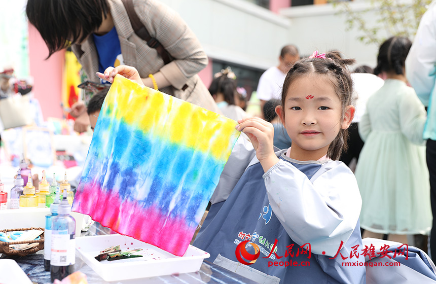 5月31日，雄安容和樂安幼兒園舉辦傳統文化游園活動?；顒友埩诵郯伯數胤沁z文化傳承人走進幼兒園，與孩子和家長交流互動。通過現場接觸非遺項目，讓孩子們零距離認識非遺、熟悉非遺，感受非遺之美。人民網 李兆民攝